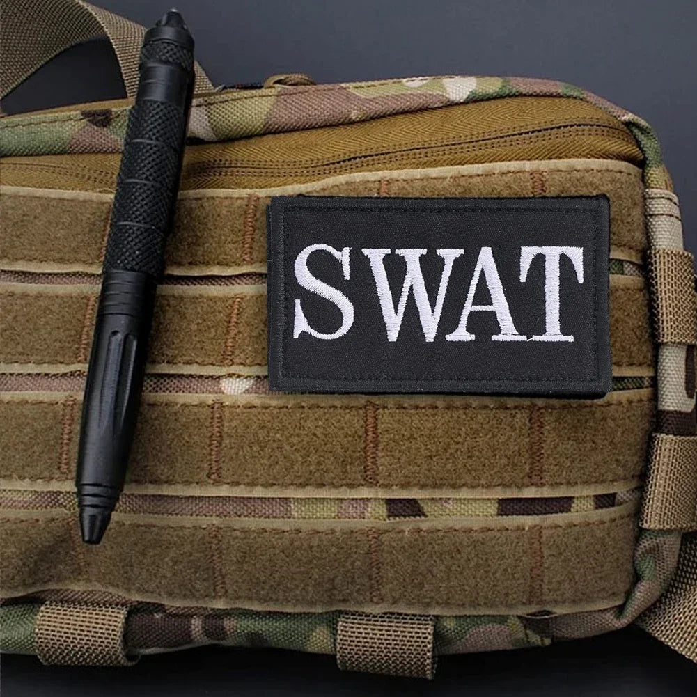 Authentic SWAT Embroidered Morale Patch - Durable High-Quality for Military Airsoft Paintball Gear - Camouflage Background